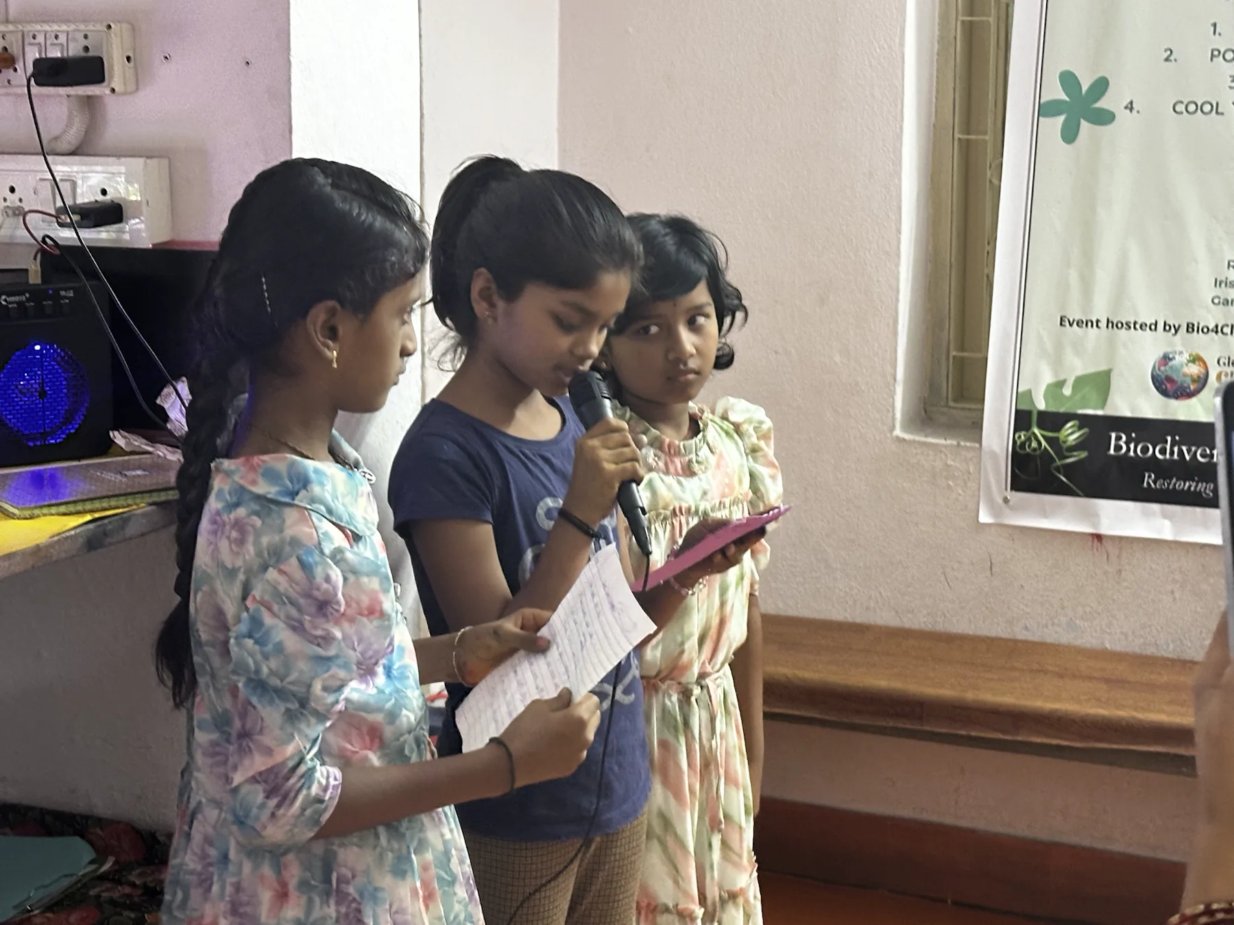 A team one participant speaks while presenting the team's tree-planting project.