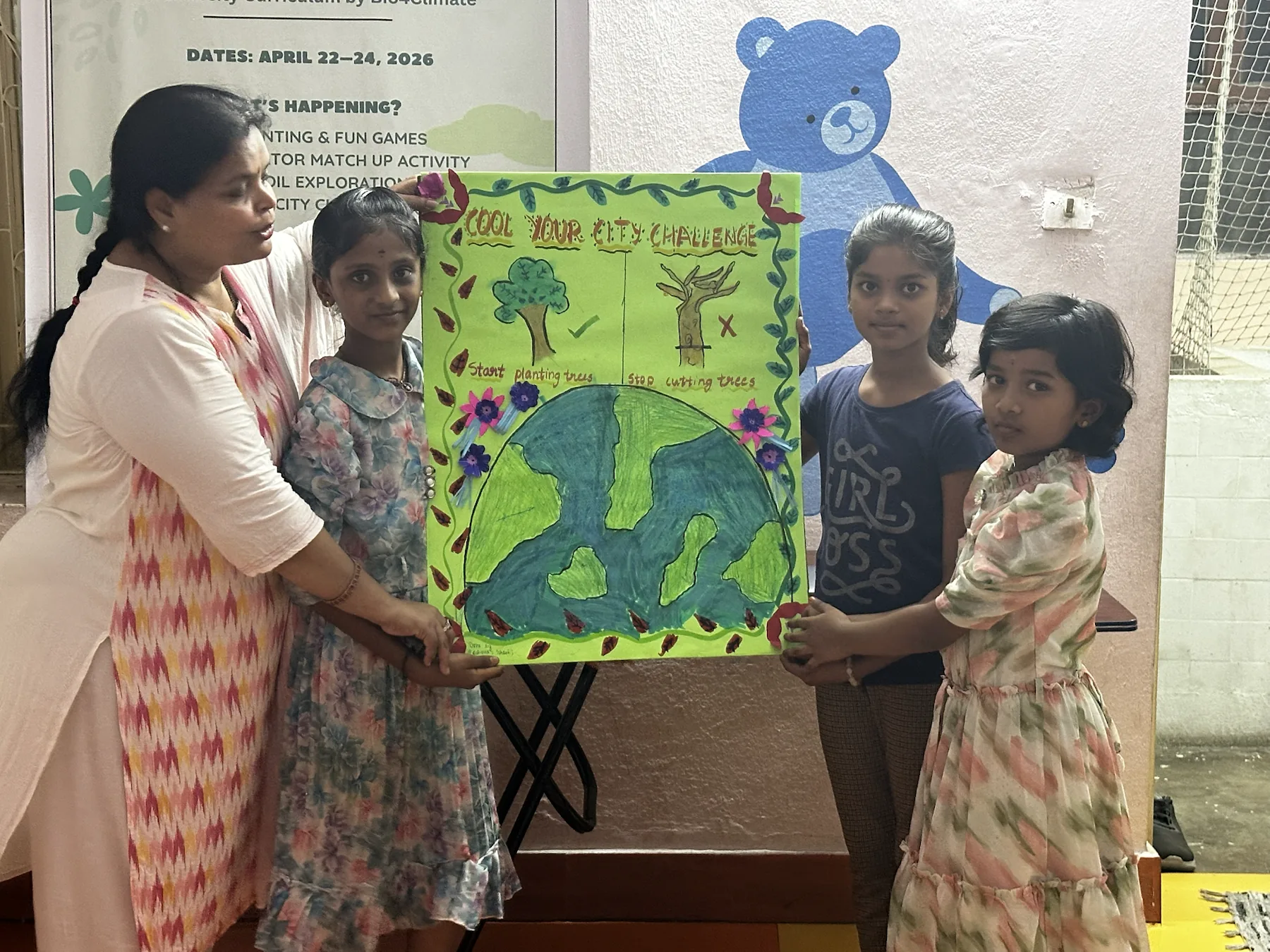 Team one stands with their handmade project calling for planting trees and protecting existing trees.