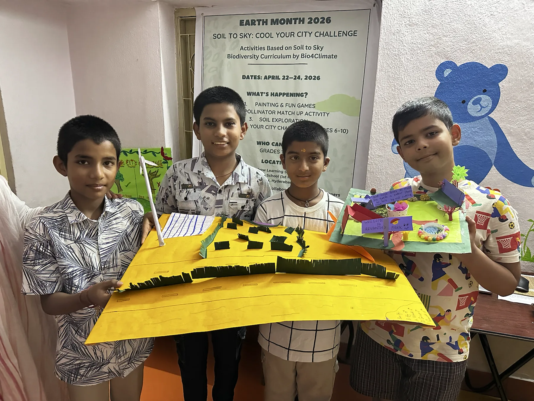 Team four presents city-cooling artifacts with green road dividers, trees, a pond, and a solar panel.