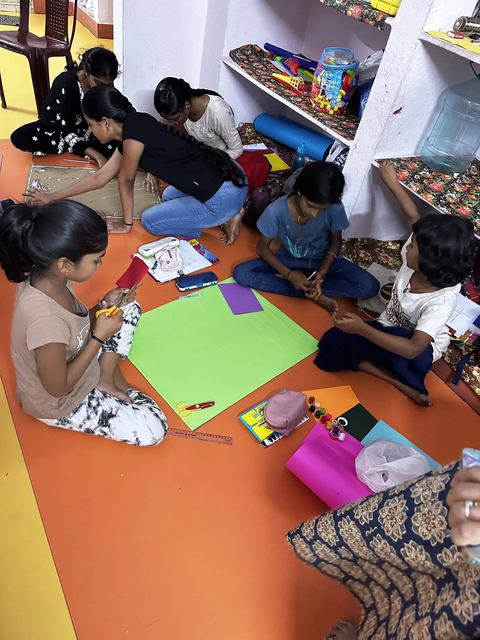 Children gather in small groups to begin preparing artwork for the Cool Your City Challenge.