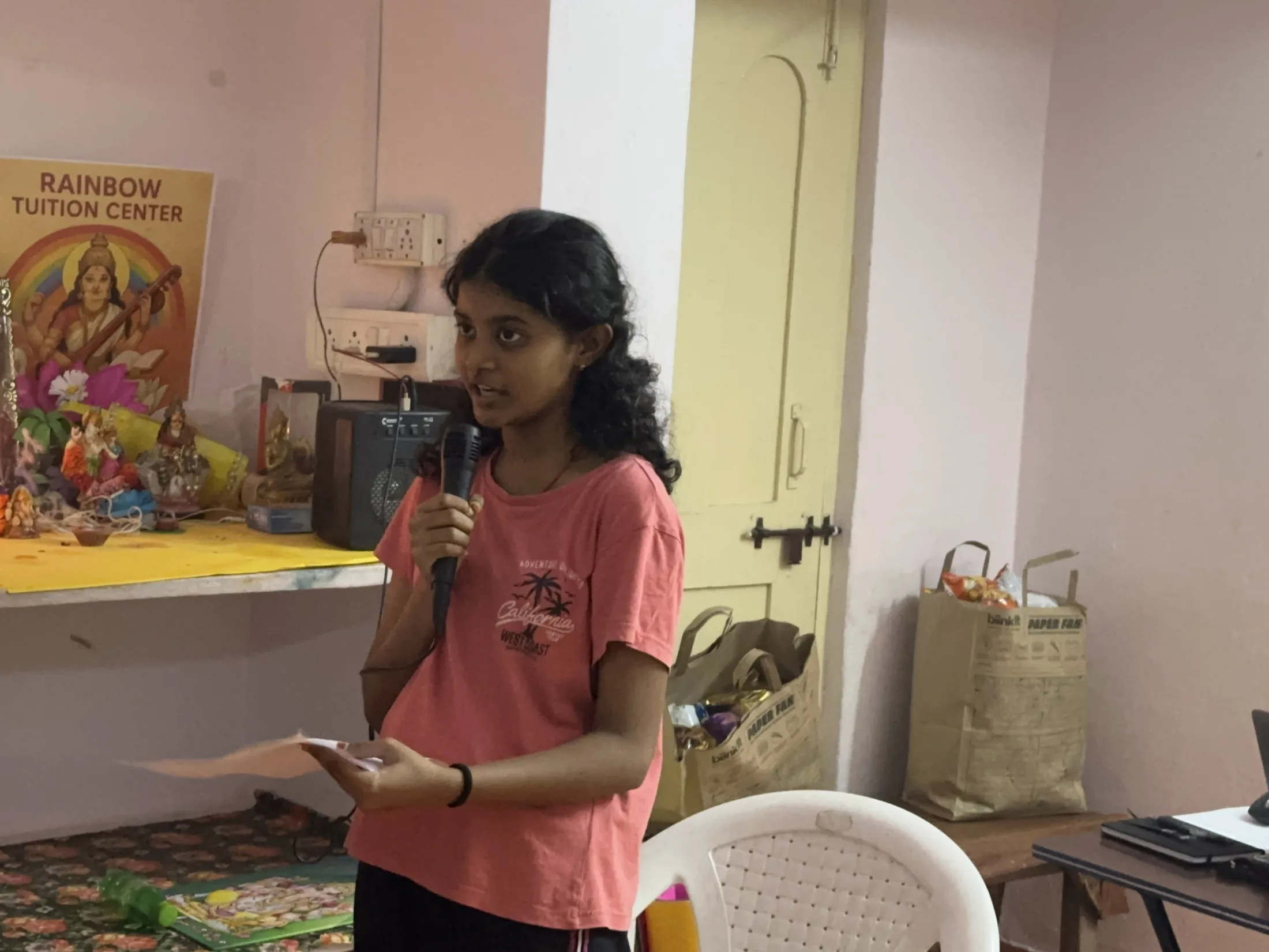 A young participant delivers a welcome speech to the gathered children.